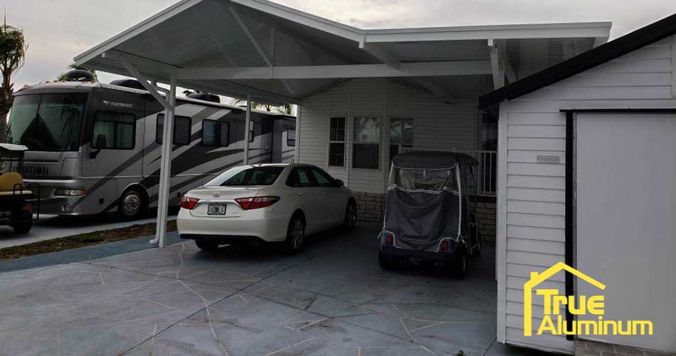 Aluminum carport with camper and car near Lakeland, FL.