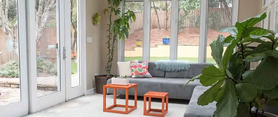 Sunroom with a door leading out to the backyard of a Wesley Chapel home.