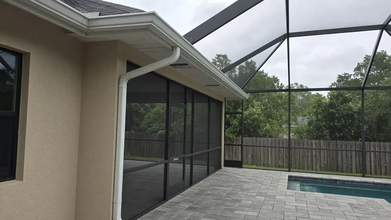 Structural gutter beam on an aluminum pool cage in a Florida backyard