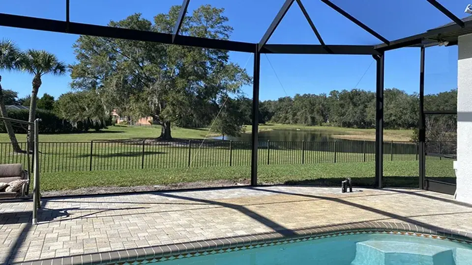 Aluminum pool cage screen enclosure over a Central Florida swimming pool