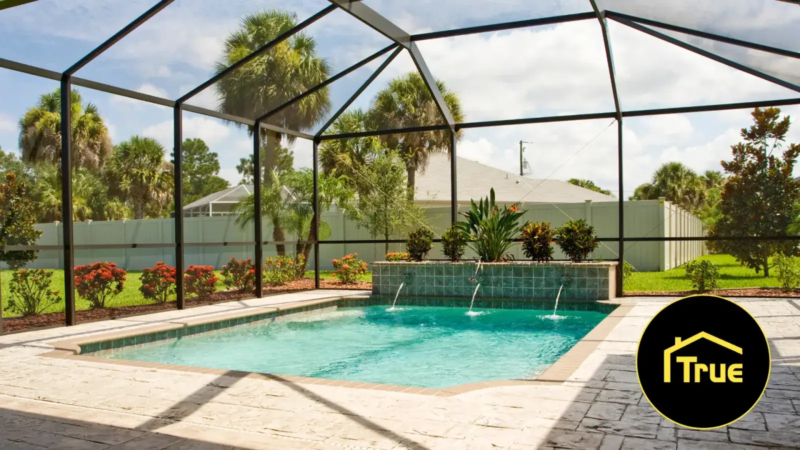 Pool screen enclosure surrounding a backyard swimming pool