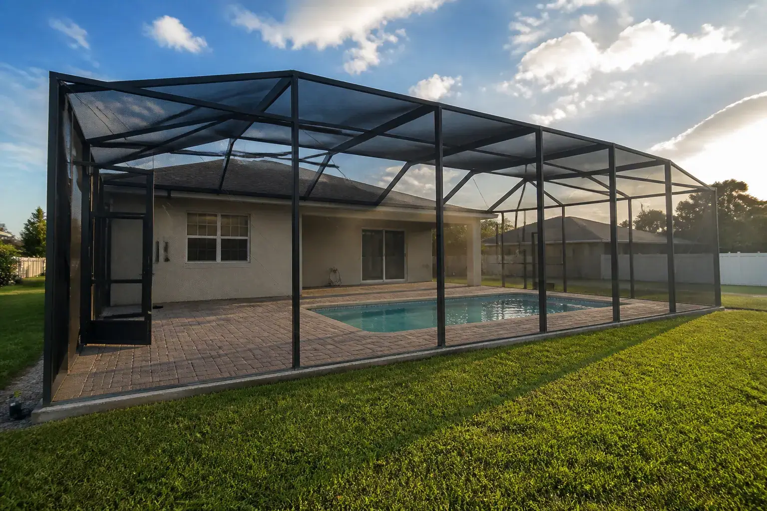 Pool cage screen enclosure over a Lakeland, FL backyard pool