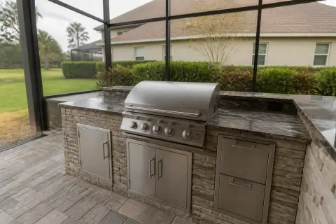 Outdoor kitchen cost in Lakeland, FL: grill island inside a screened lanai