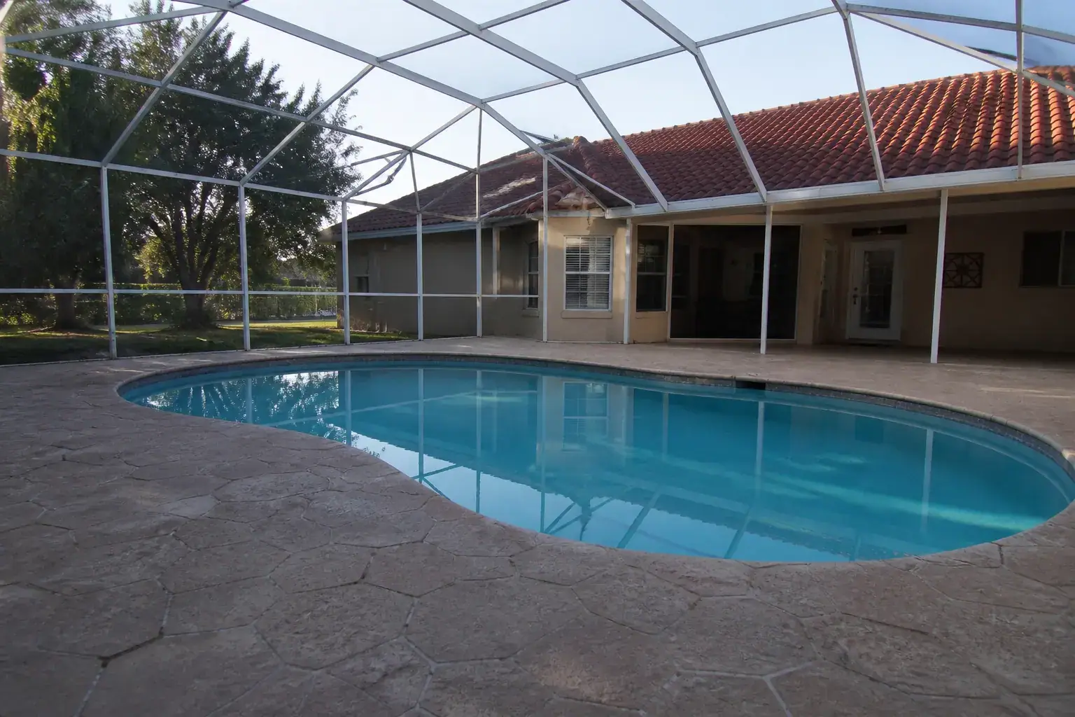 Pool cage in Plant City, FL with aluminum frame over the pool