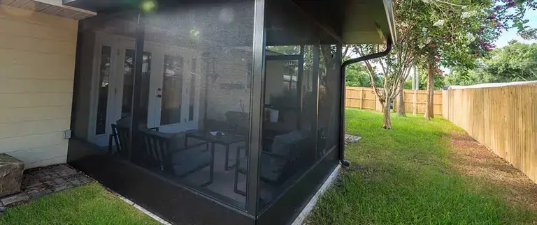 Screen room with backyard view